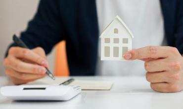 CPLP Down Payment Assistance Increased A hand holding a paper house