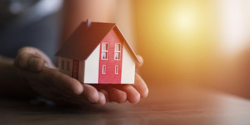 Opportunities Expand for North Carolinians With Special Housing Needs Person holding a small house in their hands over a desk