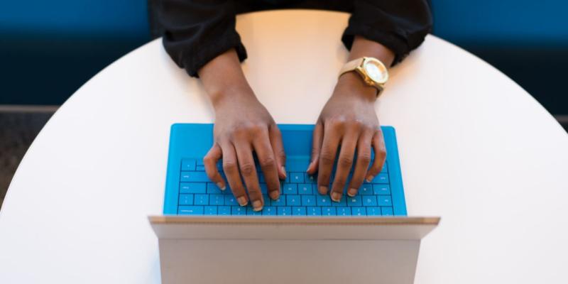 Person sitting with their hands on a keyboard